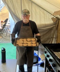 Guides preparing breakfast over the campfire at moose camp